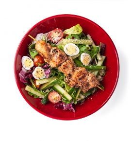 Green salad with teriyaki chicken skewer